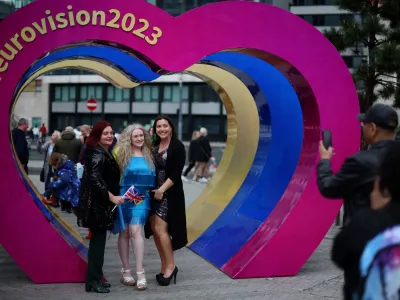 Eurovision fans pose inside a sculpture of hearts near the fanzone as part of the Eurovision celebrations in Liverpool, Britain May 8, 2023. REUTERS/Phil Noble
