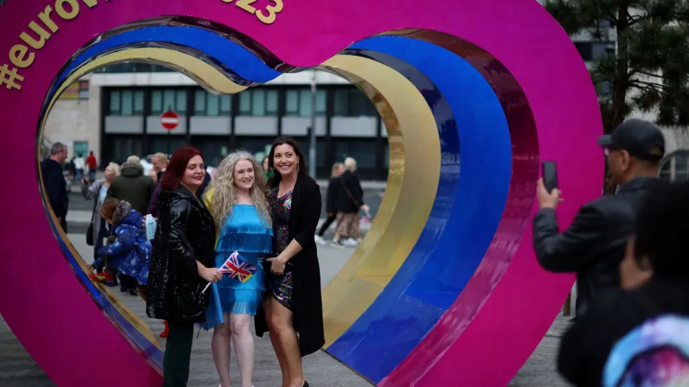 Eurovision fans pose inside a sculpture of hearts near the fanzone as part of the Eurovision celebrations in Liverpool, Britain May 8, 2023. REUTERS/Phil Noble