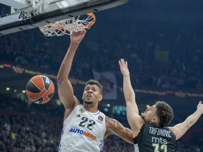 Real Madrid's Walter Tavares, left, tries to score as Partizan's Uros Trifunovic blocks him during the Euroleague basketball match between Partizan and Real Madrid, in Belgrade, Serbia, Tuesday, May 2, 2023. (AP Photo/Darko Vojinovic)