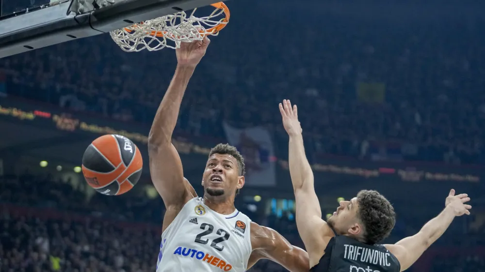 Real Madrid's Walter Tavares, left, tries to score as Partizan's Uros Trifunovic blocks him during the Euroleague basketball match between Partizan and Real Madrid, in Belgrade, Serbia, Tuesday, May 2, 2023. (AP Photo/Darko Vojinovic)