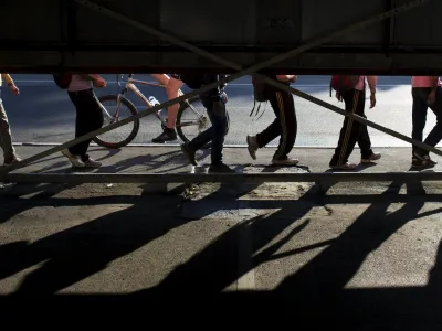 ﻿Migrants walk along a street near Belgrade's main bus and train station, in Serbia July 16, 2015. Tens of thousands of migrants from the Middle East and Africa are using the Balkan route to enter the EU, passing from Greece into Macedonia and then Serbia on their way to Hungary, which is in the EU's passport-free Schengen zone. Once there, they can move freely across most internal EU borders. Serbia is not a member of the EU, but more than 34,000 migrants have sought asylum in the former Yugoslav republic so far this year, most of them having crossed from Macedonia and Bulgaria. It is not known how many people in total have entered Serbia illegally.  REUTERS/Marko Djurica