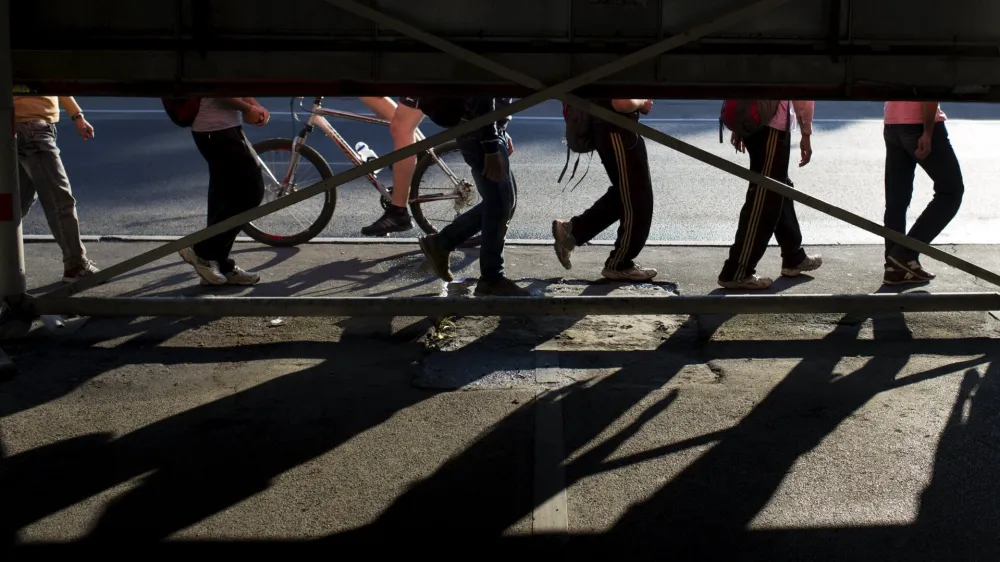 ﻿Migrants walk along a street near Belgrade's main bus and train station, in Serbia July 16, 2015. Tens of thousands of migrants from the Middle East and Africa are using the Balkan route to enter the EU, passing from Greece into Macedonia and then Serbia on their way to Hungary, which is in the EU's passport-free Schengen zone. Once there, they can move freely across most internal EU borders. Serbia is not a member of the EU, but more than 34,000 migrants have sought asylum in the former Yugoslav republic so far this year, most of them having crossed from Macedonia and Bulgaria. It is not known how many people in total have entered Serbia illegally.  REUTERS/Marko Djurica