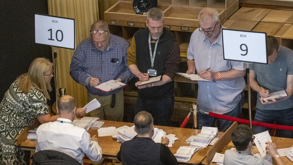 19 May 2023, United Kingdom, Belfast: Green Party NI leaders Mal O'Hara (C) tallying ballots as ballot boxes are opened in Belfast City Hall and counting begins in the Northern Ireland council elections. Photo: Liam Mcburney/PA Wire/dpa