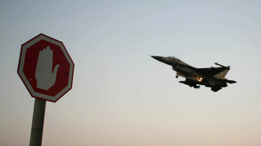 An Israeli Air Force F-16 fighter plane flying above a traffic sign after taking off for a mission in Lebanon from an Israeli Air Force Base in northern Israel in this July 20, 2006 file photo. Israeli warplanes bombed unidentified Syrian targets early on September 6, 2007, causing no damage or casualties, the official Syrian news agency said. Syrian air defences fired at the incoming planes, which crossed into Syria after midnight local time, the agency said. REUTERS/Ammar Awad/Files (ISRAEL)