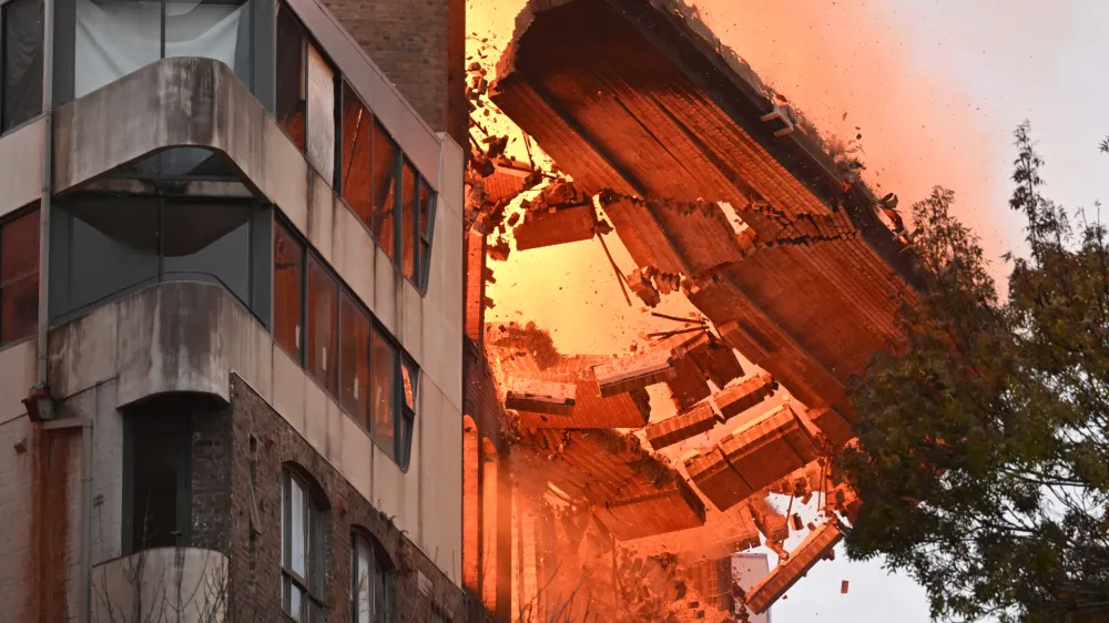 A wall collapses during a building fire in the Central Business District of Sydney, Thursday, May 25, 2023. (AAP Image/Dean Lewins) NO ARCHIVING