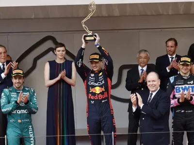 Formula One F1 - Monaco Grand Prix - Circuit de Monaco, Monte Carlo, Monaco - May 28, 2023 Red Bull's Max Verstappen celebrates with a trophy on the podium after winning the Monaco Grand Prix as Prince Albert II of Monaco with his wife Princess Charlene applaud REUTERS/Piroschka Van De Wouw