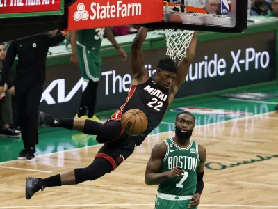May 29, 2023; Boston, Massachusetts, USA; Miami Heat forward Jimmy Butler (22) dunks against Boston Celtics guard Jaylen Brown (7) during the fourth quarter of game seven of the Eastern Conference Finals for the 2023 NBA playoffs at TD Garden. Mandatory Credit: Winslow Townson-USA TODAY Sports