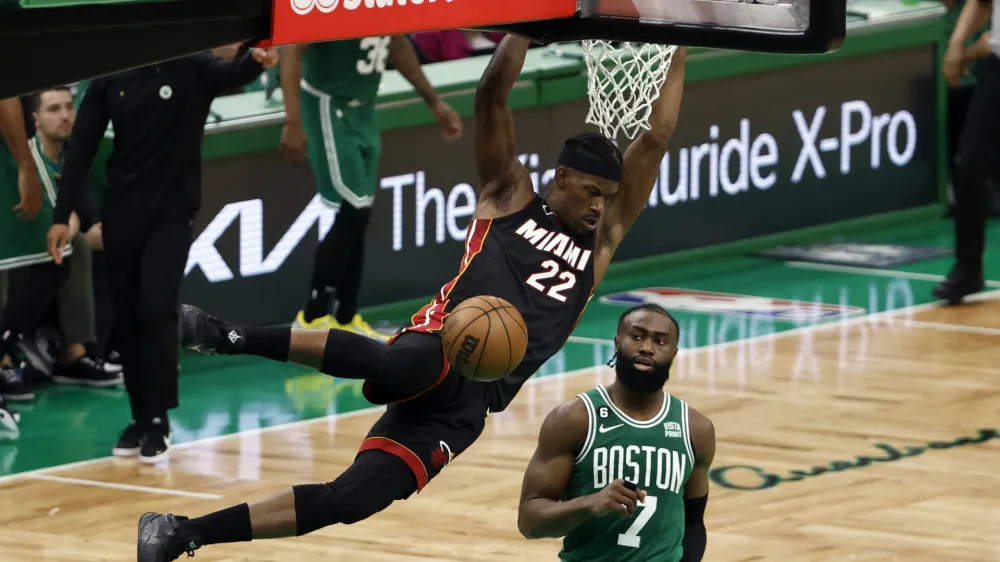 May 29, 2023; Boston, Massachusetts, USA; Miami Heat forward Jimmy Butler (22) dunks against Boston Celtics guard Jaylen Brown (7) during the fourth quarter of game seven of the Eastern Conference Finals for the 2023 NBA playoffs at TD Garden. Mandatory Credit: Winslow Townson-USA TODAY Sports