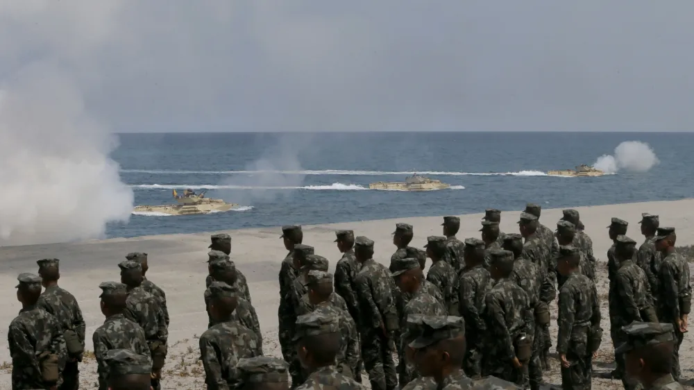 ﻿Philippine Marines watch U.S. Navy amphibious assault vehicles storm the beach during a combined assault exercise facing one of the contested islands in the South China Sea known as the Scarborough Shoal in the West Philippine Sea Tuesday, April 21, 2015 at the Naval Education and Training Command at San Antonio township, Zambales province, northwest of Manila, Philippines. More than ten thousand troops from both the U.S. and Philippine militaries are taking part in the annual military drill that focuses on regional security, terrorism, disaster preparedness and inter-operability of both countries. (AP Photo/Bullit Marquez)