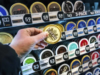 FILE - A man holds a box of snus (snuff), at a store in Stockholm, on Jan. 23, 2023. Sweden, which has the lowest rate of smoking in Europe is now close to declaring itself "smoke free," defined as having less than 5% daily smokers in the population. Some experts give credit to decades of anti-smoking campaigns and legislation, while others point to the prevalence of "snus," a smokeless tobacco product that's illegal elsewhere in the European Union but is marketed in Sweden as an alternative to cigarettes. (Claudio Bresciani /TT News Agency via AP, File)