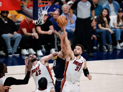 Jun 4, 2023; Denver, CO, USA; Miami Heat guard Max Strus (31) battles for a rebound with Denver Nuggets center Nikola Jokic (15) as forward Kevin Love (42) defends in the third quarter in game two of the 2023 NBA Finals at Ball Arena. Mandatory Credit: Isaiah J. Downing-USA TODAY Sports