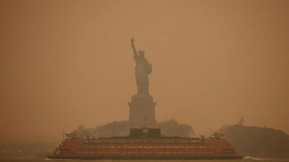 The Statue of Liberty is covered in haze and smoke caused by wildfires in Canada, in New York, U.S., June 6, 2023. REUTERS/Amr Alfiky