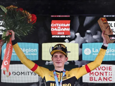 10 June 2023, France, Saint-Sorlin-Darves: Danish cyclist Jonas Vingegaard of UCI WorldTeam Team Jumbo-Visma celebrates on the podium after winning and wearing the yellow jersey of overall leader after the seventh stage of the 75th edition of the Criterium du Dauphine cycling race, 148km between Port de Savoie to Col de la Croix de Fer - Saint Sorlin. Photo: Anne-Christine Poujoulat/AFP/dpa