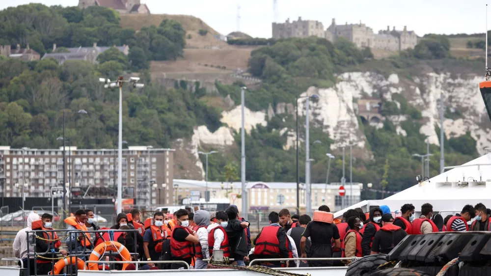 FILE PHOTO: Migrants arrive at Dover harbour onboard a Border Force vessel, after being rescued while attempting to cross the English Channel, in Dover, Britain, August 24, 2022. REUTERS/Henry Nicholls/File Photo