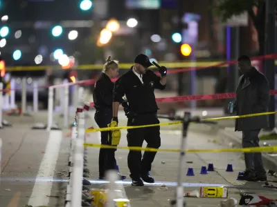 Denver Police Department investigators work the scene of a mass shooting along Market Street between 20th and 21st avenues during a celebration after the Denver Nuggets won the team's first NBA Championship early Tuesday, June 13, 2023, in Denver. (AP Photo/David Zalubowski)