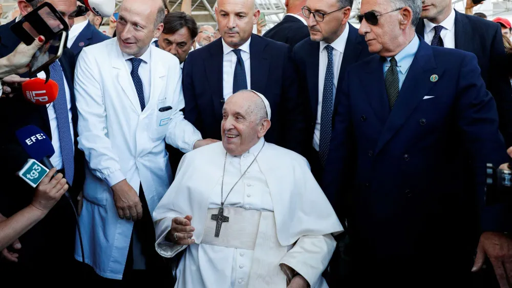 Pope Francis looks on as Dr. Sergio Alfieri, who operated on Pope Francis, stands next to him, after having been discharged from Gemelli Hospital, in Rome, Italy, June 16, 2023. REUTERS/Remo Casilli   TPX IMAGES OF THE DAY