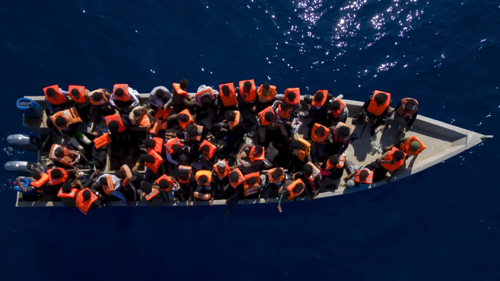 FILE - Migrants from Eritrea, Libya and Sudan sail a wooden boat before being assisted by aid workers of the Spanish NGO Open Arms, in the Mediterranean sea, about 30 miles north of Libya, Saturday, June 17, 2023. Ministers from Germany and France tasked with regulating migration are joining forces to try to curb deaths on dangerous routes across the Mediterranean Sea. The interior ministers are traveling Sunday for talks with the president and their counterpart in Tunisia, a major North African stepping stone for migrants trying to reach Europe at risk of their lives. (AP Photo/Joan Mateu Parra, File)