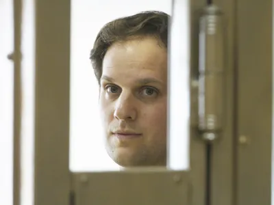 Wall Street Journal reporter Evan Gershkovich stands in a glass cage in a courtroom at the Moscow City Court in Moscow, Russia, Thursday, June 22, 2023. Gershkovich, a reporter detained on espionage charges in Russia, appeared in court Thursday to appeal his extended detention. (AP Photo/Dmitry Serebryakov)