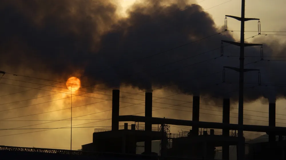 ** FILE ** Clouds of smoke billow from a metal alloy factory in Gaolan county in northwest China's Gansu province in this Nov. 7, 2006 file photo. The world's leading climate scientists, in their most powerful language ever used on the issue, said Friday Feb. 2, 2007, that global warming has started and is "very likely" manmade. The report from the Intergovernmental Panel on Climate Change - a group of hundreds of scientists and representatives of 113 governments - said global warming will continue for hundreds of years, no matter how much humans control their pollution. China is the second largest emitter of greenhouse gases, after the United States. (AP Photo) ** CHINA OUT **