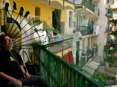 Fernando Uceta, 62, who suffers from COPD, following a double lung transplant in August 2022, uses a portable oxygen concentrator backpack with a battery to breathe as he sits in the balcony of his house before going to the Hospital del Mar for a check-up with his doctor, during the first summer heatwave, in Barcelona's Raval neighbourhood, Spain June 27, 2023. REUTERS/Nacho Doce