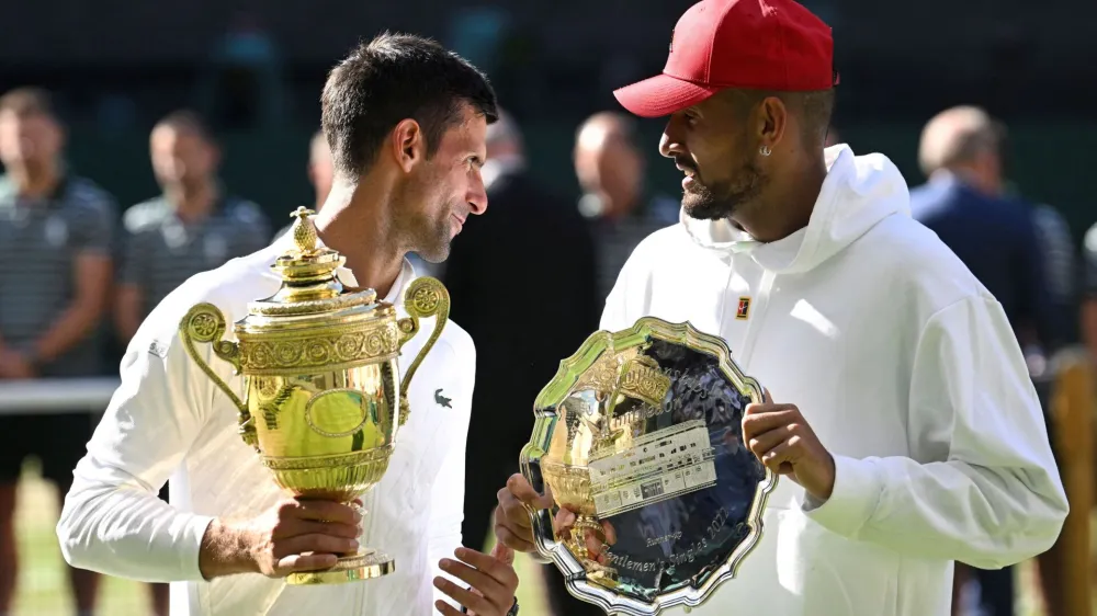 FILE PHOTO: Tennis - Wimbledon - All England Lawn Tennis and Croquet Club, London, Britain - July 10, 2022 Serbia's Novak Djokovic poses with the trophy after winning the men's singles final alongside runner up Australia's Nick Kyrgios REUTERS/Toby Melville/File Photo