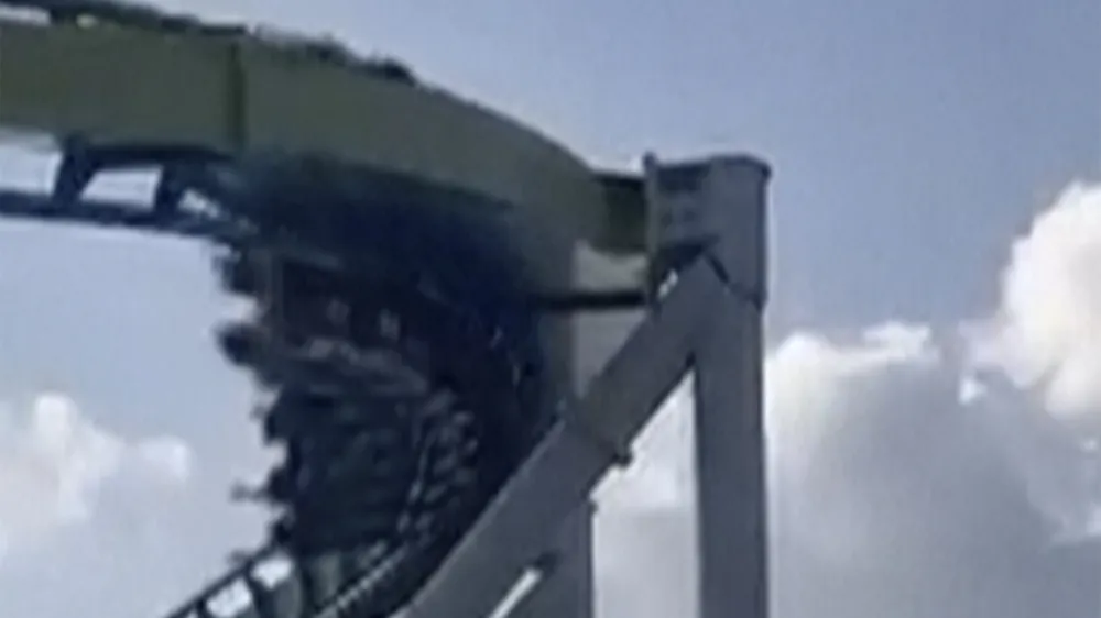 This image from video provided by Joey Mtnjunkie Puig shows a crack in a support pillar of the Fury 325 ride as a roller coaster passes by at North Carolina's Carowinds amusement park on Friday, June 30, 2023. (Joey Mtnjunkie Puig via AP)