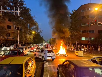 FILE PHOTO: A police motorcycle burns during a protest over the death of Mahsa Amini, a woman who died after being arrested by the Islamic republic's "morality police", in Tehran, Iran September 19, 2022. WANA (West Asia News Agency) via REUTERS/File Photo