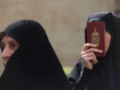 An Iranian protester holds the Koran in her hand, during a protest against a man who burned a copy of the book outside a mosque in the Swedish capital Stockholm, in front of the Swedish Embassy in Tehran, Iran July 3, 2023. Majid Asgaripour/WANA (West Asia News Agency) via REUTERS ATTENTION EDITORS - THIS PICTURE WAS PROVIDED BY A THIRD PARTY.