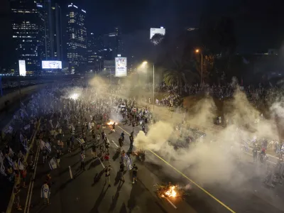 Israelis protest against plans by Prime Minister Benjamin Netanyahu's government to overhaul the judicial system, block the freeway in Tel Aviv, Israel, Wednesday, July 5, 2023. Thousands of protesters have blocked Tel Aviv's main highway and major intersections across Israel in a spontaneous outburst of anger following the ouster of the city's popular police chief. (AP Photo/Oded Balilty)