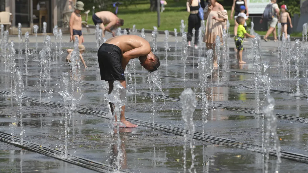 People cool off in a fountain in Moscow, Russia, Thursday, July 6, 2023. The temperatures in Moscow are over 30 Celsius (86 Fahrenheit). (AP Photo/Dmitry Serebryakov)