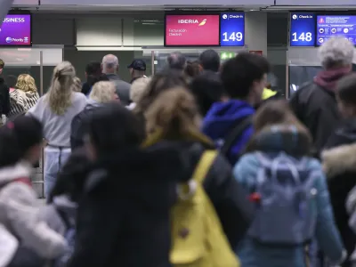 Passengers wait to be checked at an airport in Duesseldorf, Germany Thursday, April 20, 2023. A German labor union is calling for railway workers to stage an eight-hour strike on Friday to back calls for an inflation-busting pay raise. Walkouts are also scheduled at three airports this week in a parallel pay dispute. (David Young/dpa via AP)