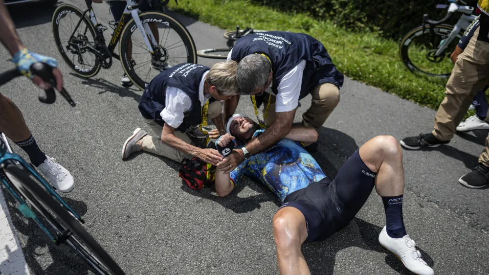 Britain's Mark Cavendish receives medical assistance after crashing during the eighth stage of the Tour de France cycling race over 201 kilometers (125 miles) with start in Libourne and finish in Limoges, France, Saturday, July 8, 2023. (AP Photo/Thibault Camus)