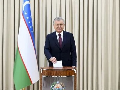 In this handout photo released by Uzbekistan's Presidential Press Office, Uzbekistan's President Shavkat Mirziyoyev casts his ballot at a polling station during a snap presidential election in Tashkent, Uzbekistan, Sunday, July 9, 2023. Uzbekistan is holding a snap presidential election, a vote that follows a constitutional referendum that extended the incumbent's term from five to seven years. President Shavkat Mirziyoyev was elected in 2021 to a second five-year term, the limit allowed by the constitution. (Uzbekistan's Presidential Press Office via AP)