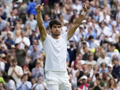 Spain's Carlos Alcaraz celebrates after beating Denmark's Holger Rune to win their men's singles match on day ten of the Wimbledon tennis championships in London, Wednesday, July 12, 2023. (AP Photo/Kirsty Wigglesworth)