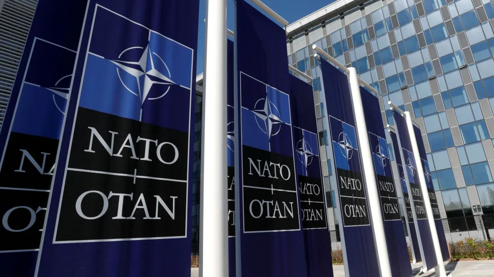 FILE PHOTO: Banners displaying the NATO logo are placed at the entrance of new NATO headquarters during the move to the new building, in Brussels, Belgium April 19, 2018. REUTERS/Yves Herman/File Photo