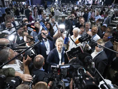 FILE - AfD's Alice Weidel, centre, answers journalists' questions after her election as the second, equal federal spokeswoman at the AfD's federal party conference in Riesa, Germany, June 18, 2022. Prominent members of German mainstream parties have expressed alarm at a new poll released Thursday June 1, 2023, showing support for the far-right Alternative for Germany at a record high. (Sebastian Kahnert/dpa via AP, File)