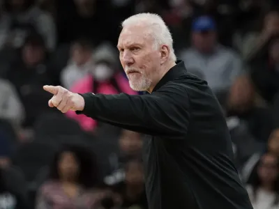 San Antonio Spurs coach Gregg Popovich signals to players during the first half of an NBA basketball game against the Utah Jazz, Friday, March 11, 2022, in San Antonio. (AP Photo/Eric Gay)