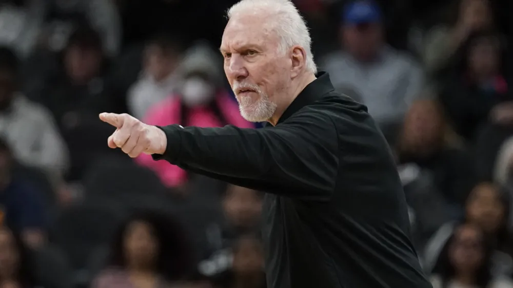 San Antonio Spurs coach Gregg Popovich signals to players during the first half of an NBA basketball game against the Utah Jazz, Friday, March 11, 2022, in San Antonio. (AP Photo/Eric Gay)