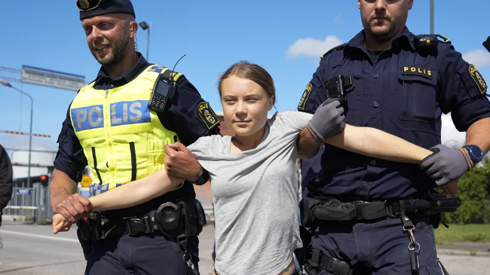 Climate activist Greta Thunberg is detained by police during an action for blocking the entrance to an oil facility in Malmo, Sweden, Monday, July 24, 2023. The protest took place just a few hours after Thunberg was fined for disobeying police during a similar protest last month at the same terminal. (AP Photo/Pavel Golovkin)