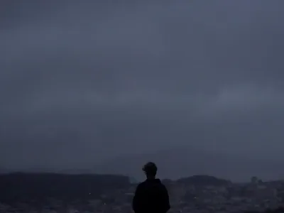 A person looks north from Grand View Park in San Francisco, Wednesday, Jan. 11, 2023. Storm-ravaged California is scrambling to clean up and repair widespread damage. (AP Photo/Jeff Chiu)