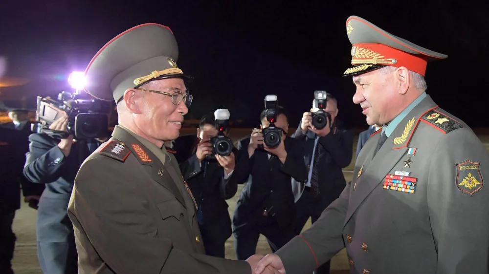 HANDOUT - 25 July 2023, North Korea, Pyongyang: A photo released by the North Korean state news agency (KCNA) on 26 July 2023 shows North Korean Defence Minister Kang Sun-nam (L) receiving Russian Defence Minister Sergey Shoigu (R) upon his arrival at an airport in North Korea's capital Pyongyang. According to official information, Russia's Defence Minister Sergei Shoigu has visited neighbouring North Korea for a three-day visit. Photo: -/KCNA/KNS/dpa - ATTENTION: editorial use only and only if the credit mentioned above is referenced in full