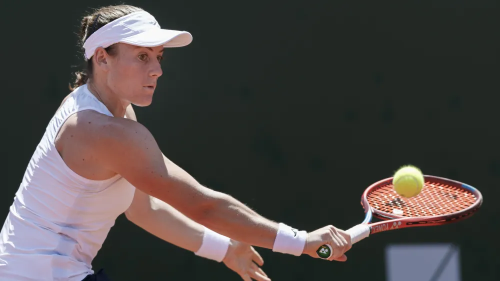 ﻿Tamara Zidansek from Slovenia returns a ball to Clara Burel from France during the final match at the tennis WTA International Ladies open in Lausanne, Switzerland, Sunday, July 18, 2021. (Cyril Zingaro/Keystone via AP)