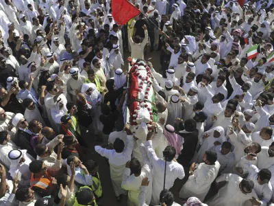 FILE - Thousands of Sunnis and Shiites from across the country take part in a mass funeral procession for 27 people killed in a suicide bombing, at the Grand Mosque in Kuwait City, Kuwait, on June 27, 2015. Kuwait said Thursday, July 27, 2023, it executed five prisoners, including an inmate convicted over the Islamic State group-claimed mosque bombing in 2015. (AP Photo, File)