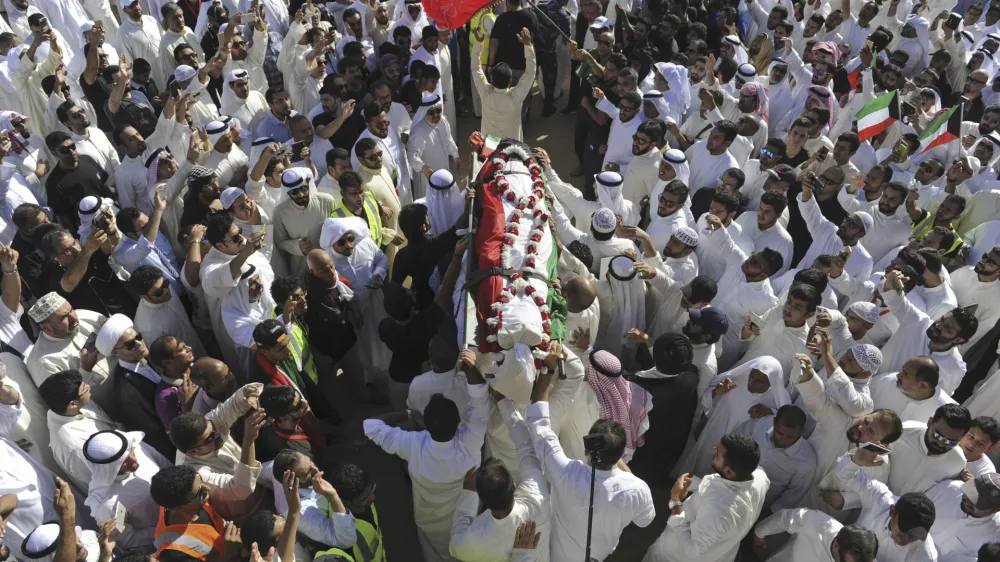 FILE - Thousands of Sunnis and Shiites from across the country take part in a mass funeral procession for 27 people killed in a suicide bombing, at the Grand Mosque in Kuwait City, Kuwait, on June 27, 2015. Kuwait said Thursday, July 27, 2023, it executed five prisoners, including an inmate convicted over the Islamic State group-claimed mosque bombing in 2015. (AP Photo, File)