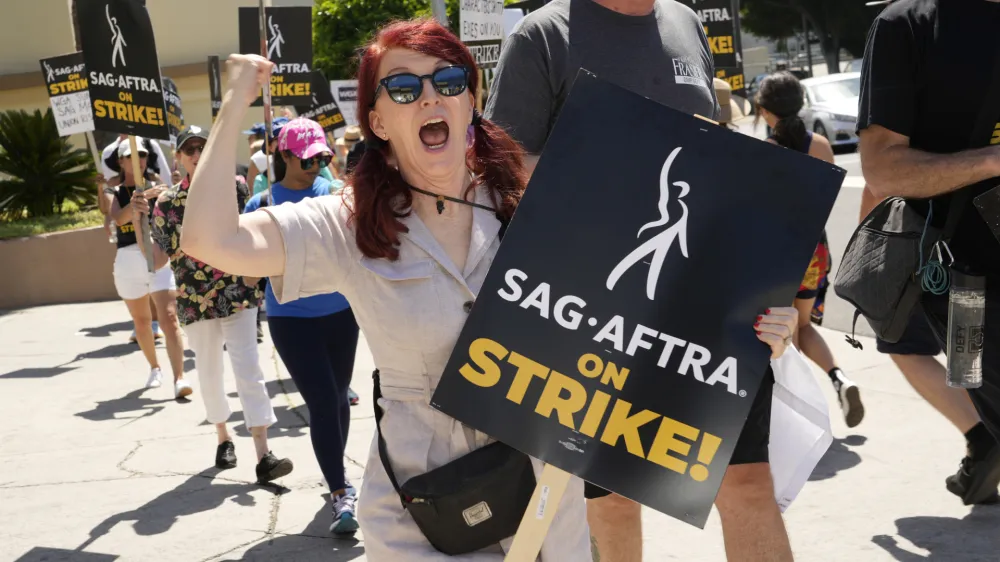 Kate Flannery appears on a picket line outside Paramount studios on Wednesday, July 26, 2023, in Los Angeles. The actors strike comes more than two months after screenwriters began striking in their bid to get better pay and working conditions. (AP Photo/Chris Pizzello)