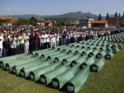 ﻿Bosnian Muslims pray near the coffins of relatives during mass funeral for bodies found in a mass grave, in Kozarac, near Prijedor, July 20, 2014. The collective burial of 284 Bosnian Muslims and Croats, whose remains were found and identified in a northwestern mass grave and believed to be the largest from Bosnia's 1992-95 war, will take place on Sunday. REUTERS/Dado Ruvic (BOSNIA AND HERZEGOVINA - Tags: POLITICS CIVIL UNREST CONFLICT RELIGION)