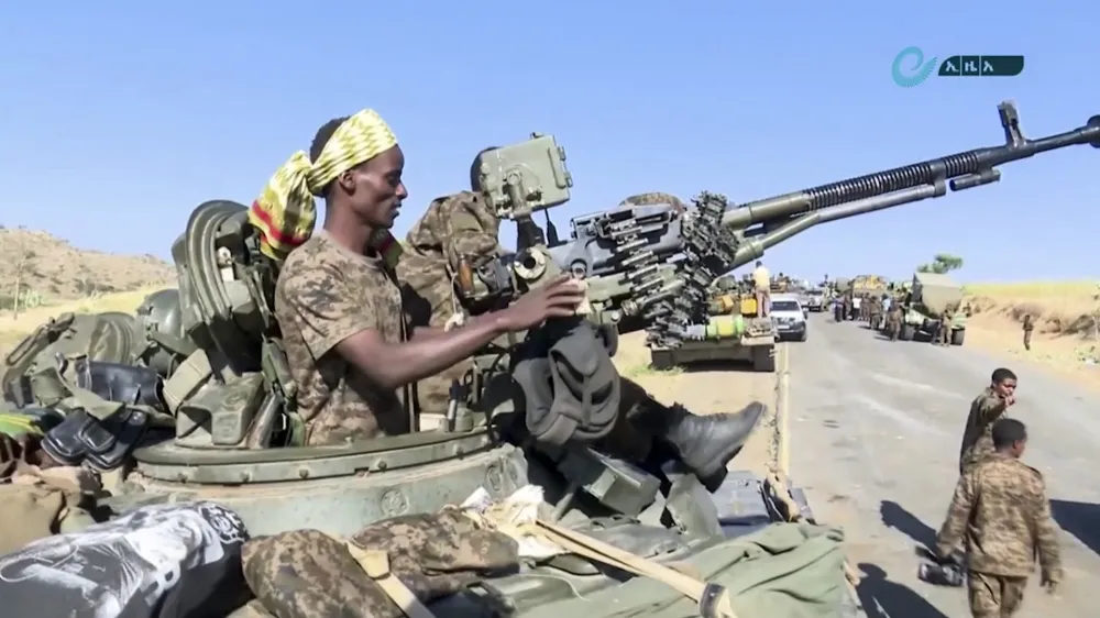This image made from undated video released by the state-owned Ethiopian News Agency on Monday, Nov. 16, 2020 shows Ethiopian military in an armored personnel carrier, on a road in an area near the border of the Tigray and Amhara regions of Ethiopia. Ethiopia's prime minister Abiy Ahmed said in a social media post on Tuesday, Nov. 17, 2020 that "the final and crucial" military operation will launch in the coming days against the government of the country's rebellious northern Tigray region. (Ethiopian News Agency via AP)