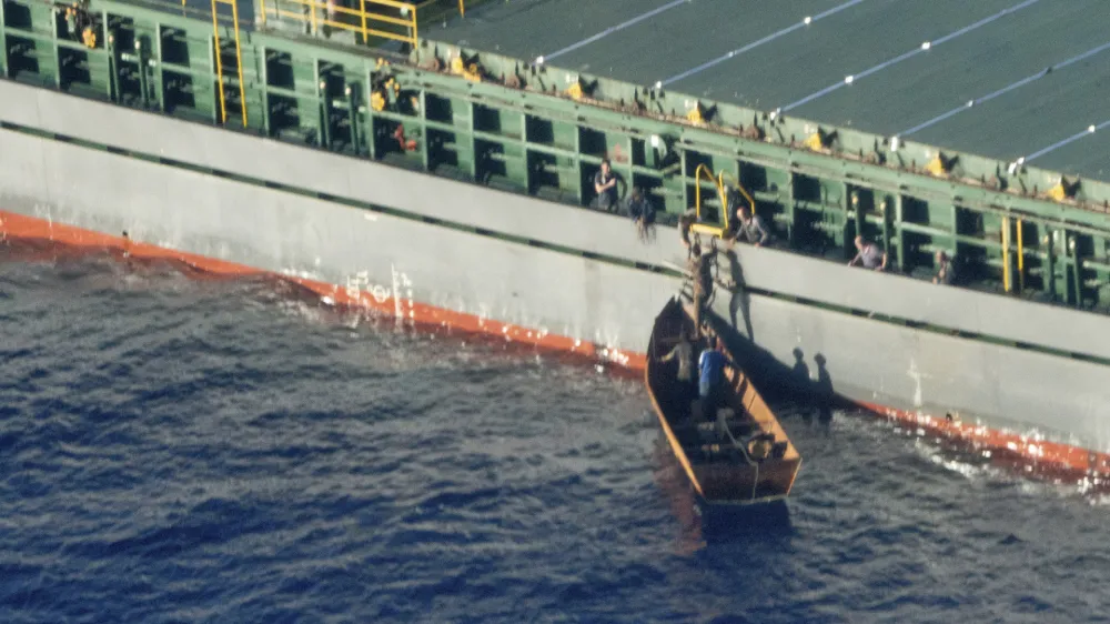 Four migrant survivors board on a commercial tanker, the Maltese-flagged Rimona, Tuesday, Aug. 8, 2023. Forty-one people are believed dead after a boat carrying migrants capsized off Tunisia in rough seas, the Italian Red Cross and rescue groups reported, citing four survivors who were rescued and brought to land Wednesday. The survivors reported having left Sfax, Tunisia, on a metal boat with a total of 45 people on Aug. 3. About six hours into their voyage, a huge wave overturned the vessel, RAI state television reported. (Karolina Sobel/Sea-Watch Via AP)