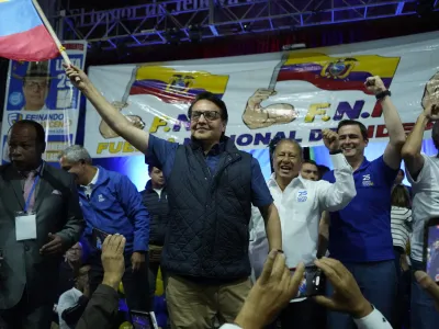 Presidential candidate Fernando Villavicencio waves an Ecuador national flag during a campaign event at a school minutes before he was shot to death outside the same school in Quito, Ecuador, Wednesday, Aug. 9, 2023 (API via AP)