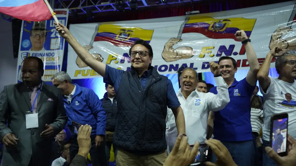 Presidential candidate Fernando Villavicencio waves an Ecuador national flag during a campaign event at a school minutes before he was shot to death outside the same school in Quito, Ecuador, Wednesday, Aug. 9, 2023 (API via AP)